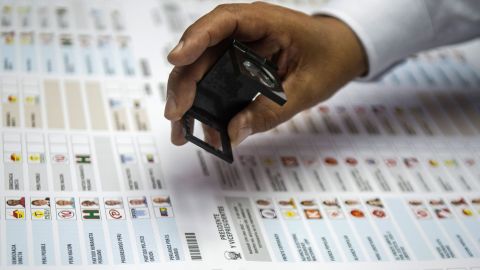 A worker of Peru's National Office of Electoral Processes (ONPE) checks electoral material in Lima on March 12, 2016 during a colour test of more than 23 million ballot papers for the upcoming April10 general election.   AFP PHOTO/ERNESTO BENAVIDES / AFP / ERNESTO BENAVIDES        (Photo credit should read ERNESTO BENAVIDES/AFP/Getty Images)