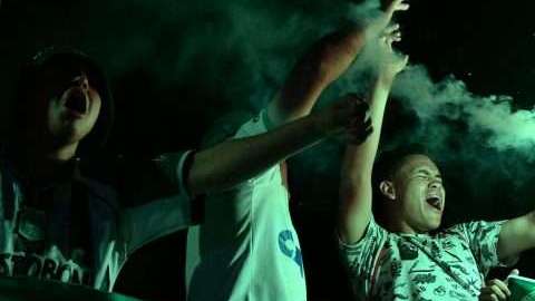 People attend a ceremony in honour of the victims and survivors of Lamia flight 2933 on the first anniversary of the plane crash in Colombia that wiped out Brazilian football club Chapecoense, at the Arena Conda stadium in Chapeco, Santa Catarina, Brazil on November 28 2017. 
The plane was flying Chapecoense to Medellin to take on Atletico Nacional in the Copa Sudamericana finals -- the biggest and most unexpected game in the Brazilian team's history. When the plane ran out of fuel and went down in inhospitable mountains near its destination 71 of the 77 aboard died including 19 players. / AFP PHOTO / NELSON ALMEIDA        (Photo credit should read NELSON ALMEIDA/AFP/Getty Images)