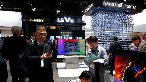 Personas observan un televisor del stand de LG durante el Salón Internacional de la Feria de Electrónica de Consumo.