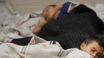 Niños migrantes duermen en un albergue temporal.