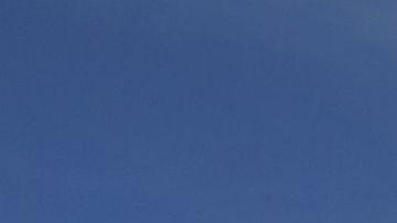 Cristina Bautista y Joaquina García posan con fotos de sus hijos, Benjamín Ascencio Bautista y Martín Getsemaní Sánchez García durante un plantón frente al Consulado de México en Los Ángeles.  (Aurelia Ventura/La Opinion)