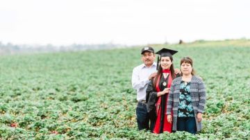 Erica Alfaro con sus padres en los campos de frutas de Carlsbad, California.