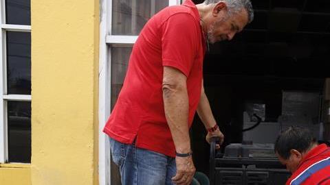 Personas preparan un generador de energía para una casa en Yabucoa, Puerto Rico.