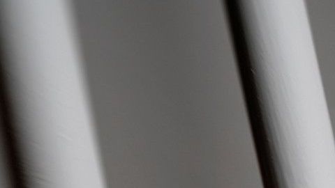 Hands on prison bars