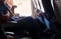 Una mujer abre la puerta de emergencia durante un vuelo.