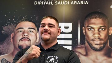 Mexican-American heavyweight boxing champion Andy Ruiz Jr poses before a poster of the upcoming "Clash on the Dunes" fight between him and British challenger Anthony Joshua, set to take place in December, at a press conference in Diriya on the western outskirts of the Saudi capital Riyadh on September 4, 2019. - The "Clash on the Dunes" is scheduled to take place in Diriya on December 7. (Photo by Fayez Nureldine / AFP)        (Photo credit should read FAYEZ NURELDINE/AFP via Getty Images)