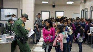 Agentes de inmigración procesan las solicitudes de asilo en la frontera.