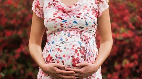 0_Pregnant-Caucasian-woman-holding-her-belly-outdoors