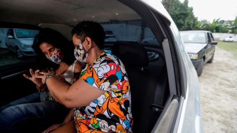 Ana Lucia Almano (L) and Carla Pinheiro de Almeida (R), exchange rings during their wedding inside a car, during COVID-19 pandemic, in Rio de Janeiro, Brazil, 14 May 2020. A judge managed to calm the eagerness of boyfriends and girlfriends and organized 'Drive thru' weddings, a service that provides directly in cars, so that the couple can join their hearts without exposing themselves to the risk of the virus.