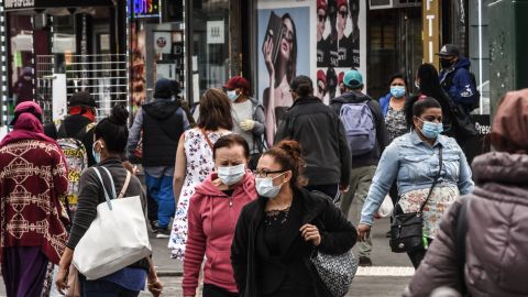 NEW YORK, NY - MAY 19 :  People cross the street on May 19, 2020 in the Jamaica neighborhood in the Queens borough in New York City. New York City is currently in its ninth week of lockdown and governmental guidelines on wearing a mask in public and social distancing are in effect. (Photo by Stephanie Keith/Getty Images)