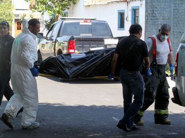 MEXICO-CRIME-CORPSES
Forensic personnel carry one of the corps found at the crime scene of a clandestine grave located inside a house in Guadalajara, Jalisco State, Mexico on August 3, 2018. - The prosecutor´s office of the state of Jalisco reported at least ten bodies have been found in a clandestine grave, Guadalajara is the second Mexican city and has a strong presence of organised crime. (Photo by ULISES RUIZ / AFP)        (Photo credit should read ULISES RUIZ/AFP via Getty Images)