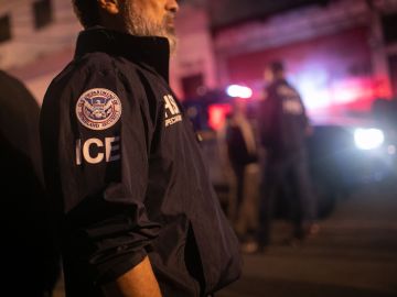 GUATEMALA CITY, GUATEMALA - MAY 29: An ICE agent with U.S. Homeland Security Investigations (HSI), watches as Guatemalan police investigate the scene after detaining a suspected human trafficker on May 29, 2019 in Guatemala City. Homeland Security agents accompanied Guatemalan police on an early morning raid, the first since Acting U.S. Homeland Security Secretary Kevin McAleenan signed an agreement with his Guatemalan counterparts, increasing cooperation on human and drug smuggling. McAleenan is on a four-day trip to Guatemala. (Photo by John Moore/Getty Images)