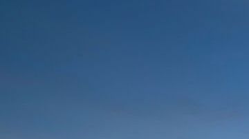 La pareja no se percató que la ola se acercaba a ellos.