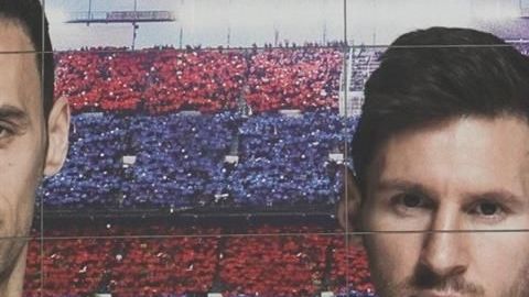 Messi en un cartel cerca de la estatua de Johan Cruyff.