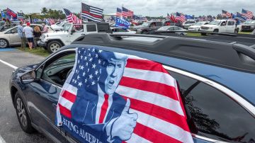 Un vehículo con una bandera de apoyo a Donald Trump durante la marcha celebrada este domingo en Miami.