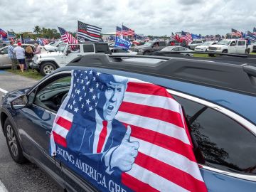 Un vehículo con una bandera de apoyo a Donald Trump durante la marcha celebrada este domingo en Miami.