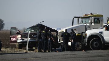 Los investigadores examinan la escena de un accidente entre una camioneta y un camión lleno de grava cerca de Holtville, California, el 2 de marzo de 2021.