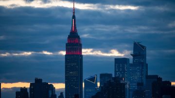 El Empire State Building se ilumina con una "sirena" blanca y roja en su mástil para rendir homenaje a los trabajadores médicos que luchan contra el  coronavirus el 1 de abril de 2020 en Nueva York.