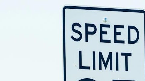 sign on roadside with speed limit