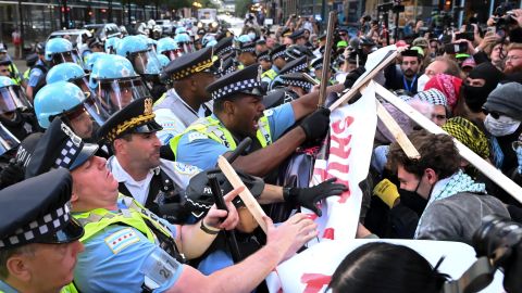 Policías y manifestantes pro Palestina chocan durante una protesta el 20 de agosto de 2024 frente al Consulado de Israel en Chicago.