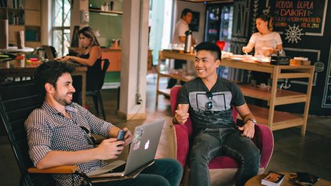 photograph of men having conversation seating on chair