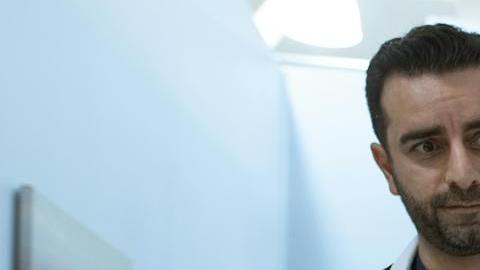 man in white medical scrub suit standing beside girl in blue denim jacket